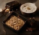 An open box with cookies and a cup